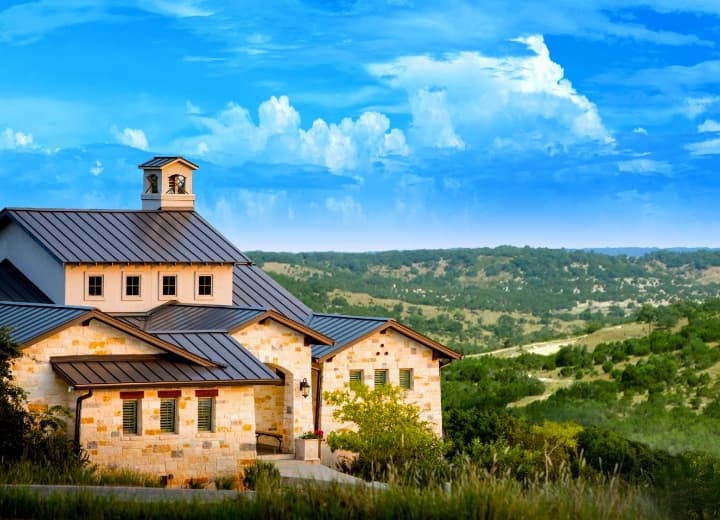 A house on a hill overlooking a valley.