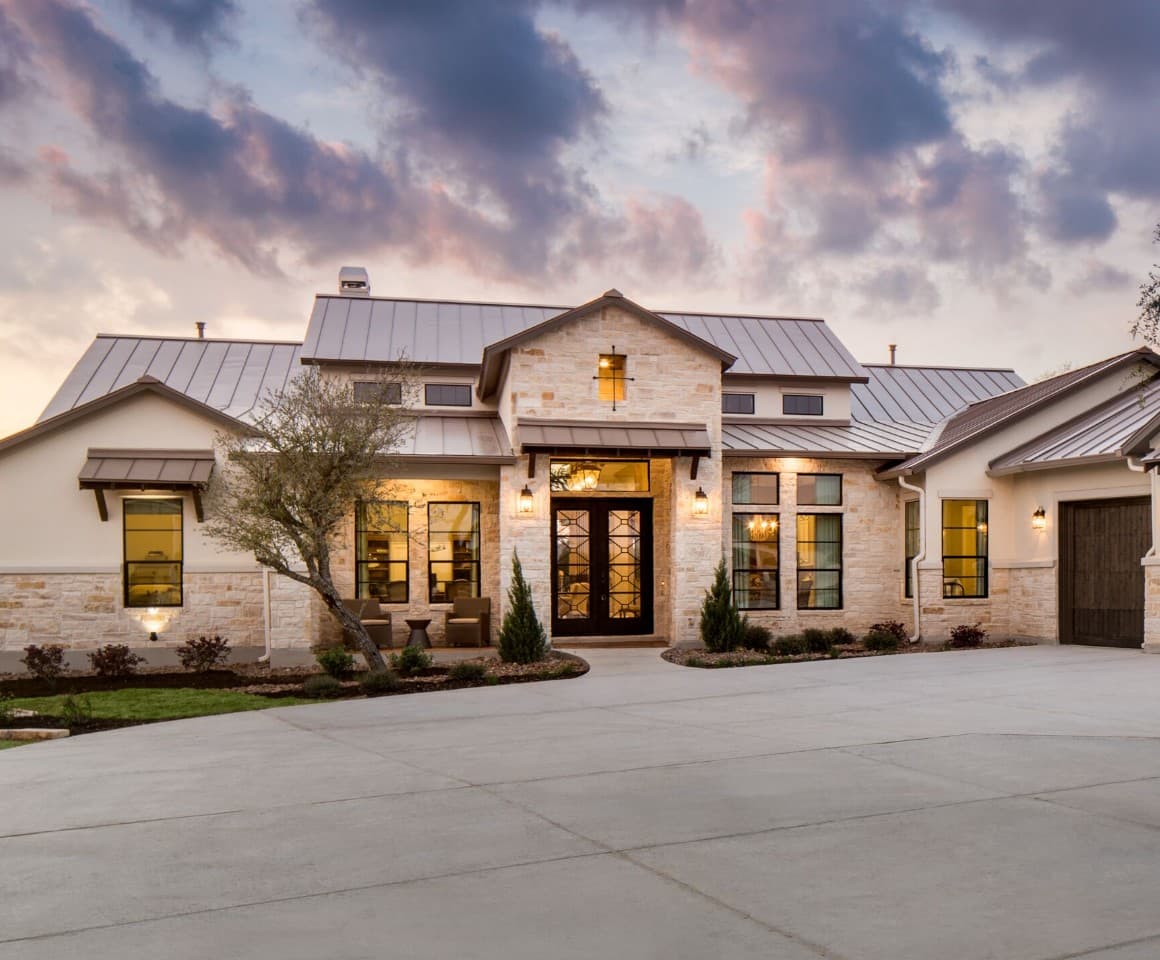 A home with a garage and driveway at dusk.