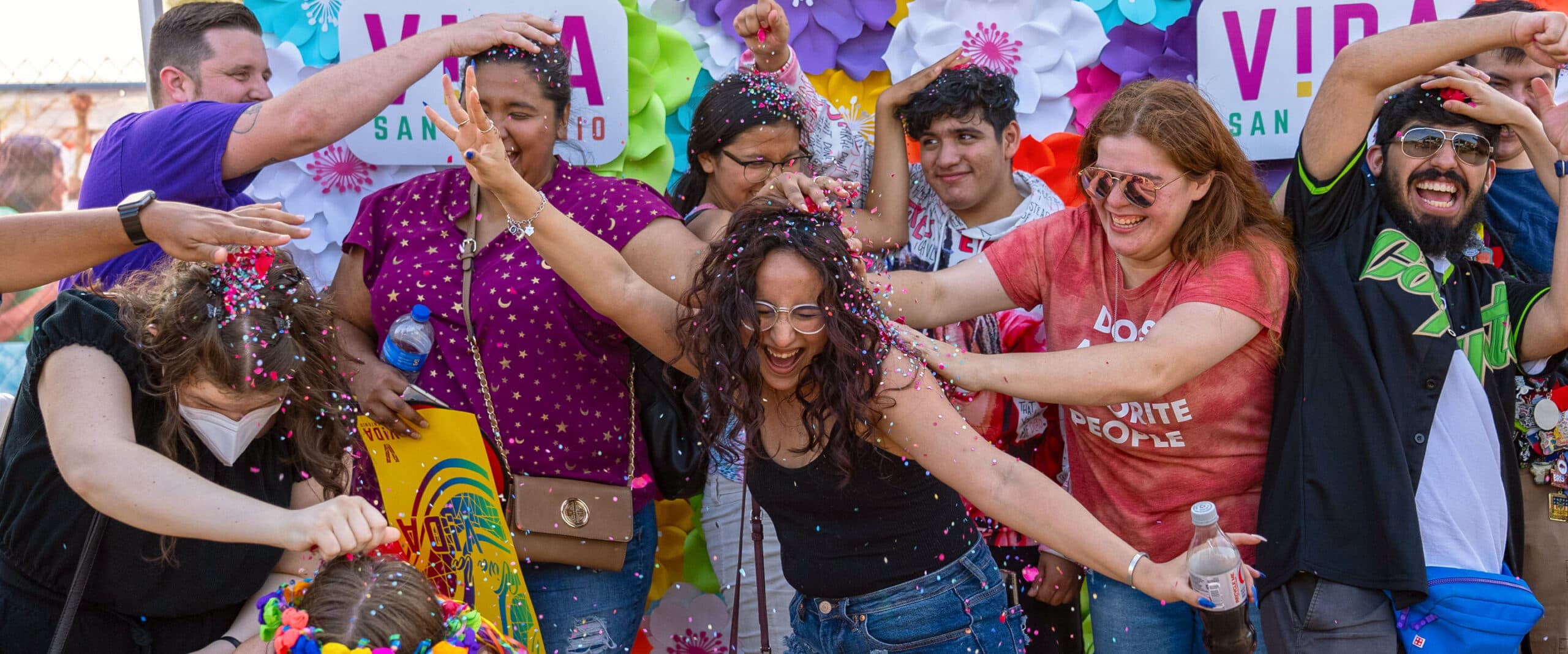 A group of people are throwing confetti at each other.