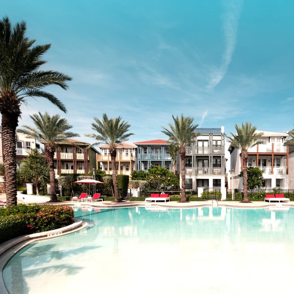 Marlin Bay Yacht Club pool with lounge chairs and palm trees in the background.